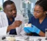 Dental professionals discuss implant crown retention using a single-crown model.